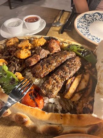 A plate of food with a fork in it on a table.