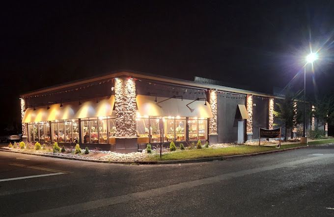 A large building with a lot of windows is lit up at night