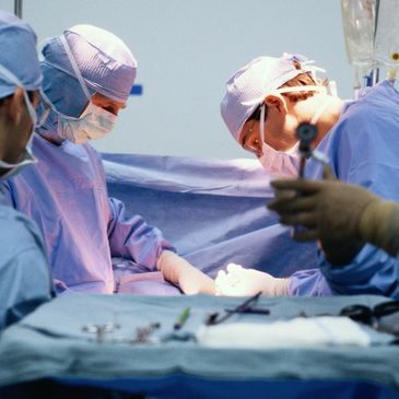 A group of surgeons are performing surgery on a patient