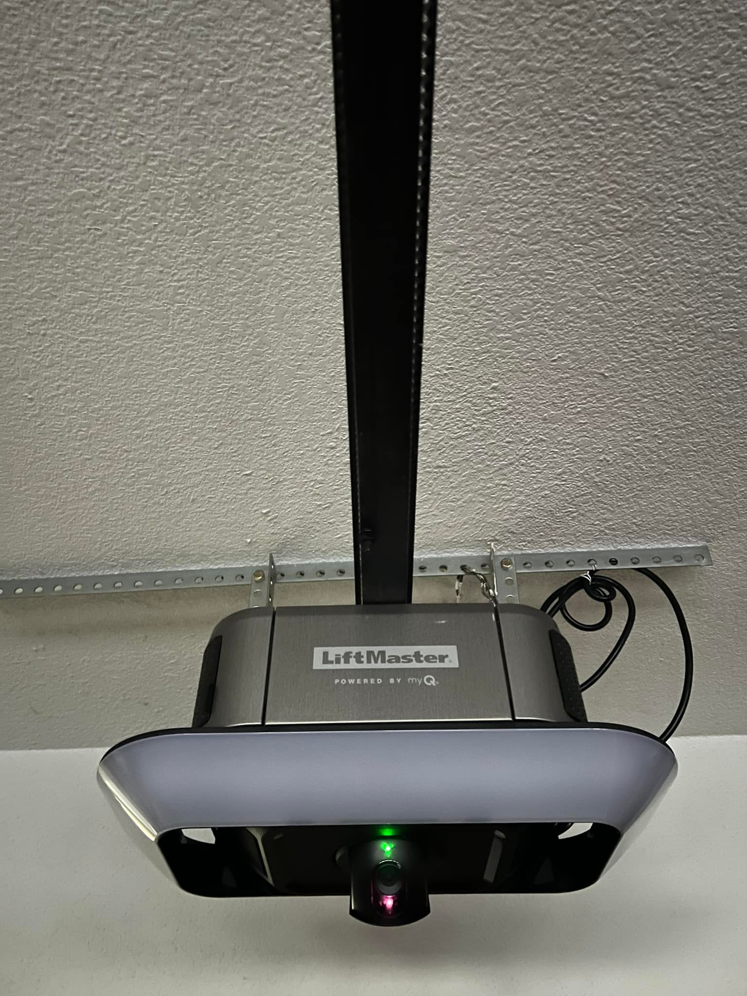 LiftMaster garage door opener with integrated light and green LED indicator.