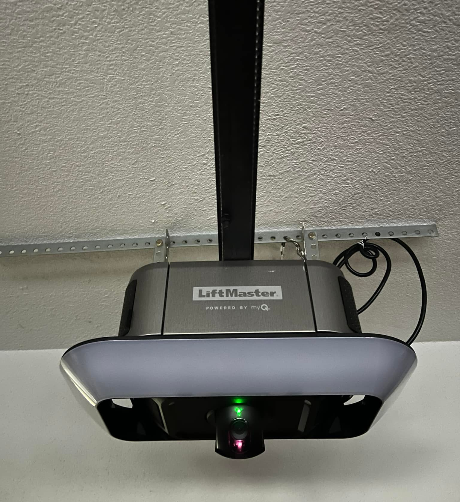 LiftMaster garage door opener with a green light illuminated.