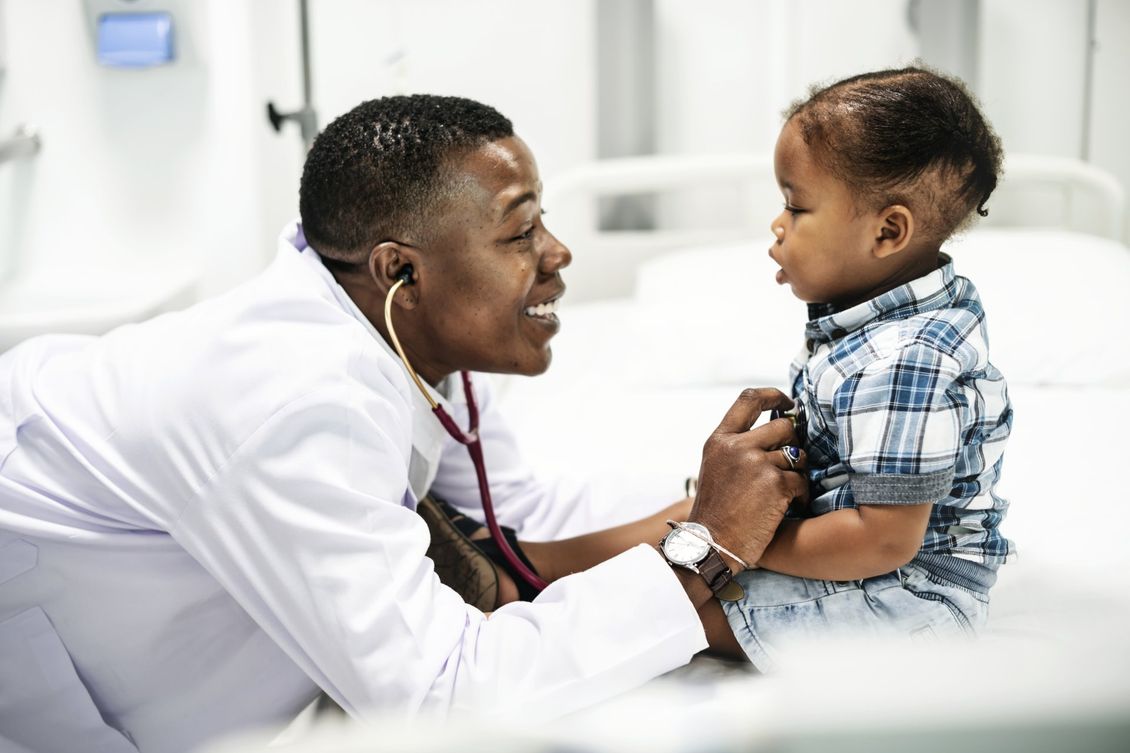 doctor checking toddler boy