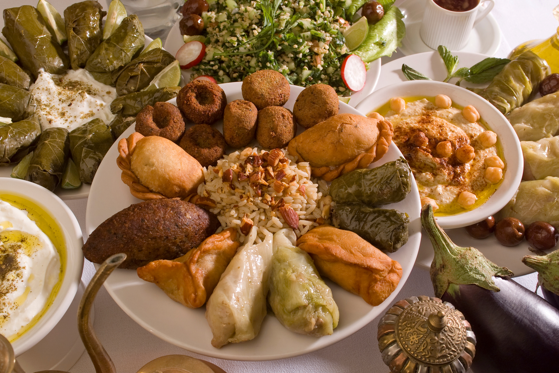 A table topped with plates of food and vegetables.