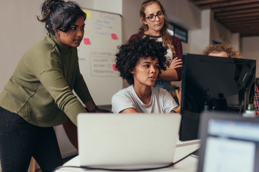 A group of women IT professionals working on an IT project.