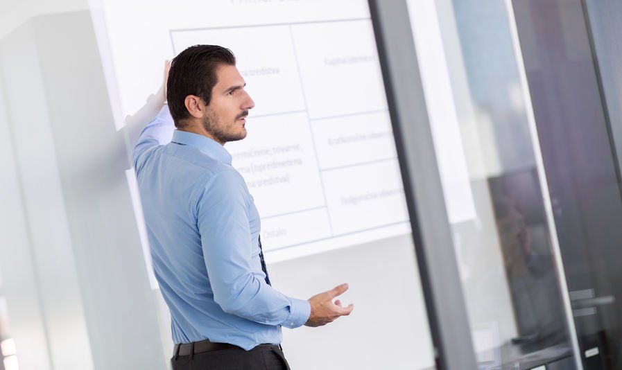 A male IT technology strategist conducting a presentation.