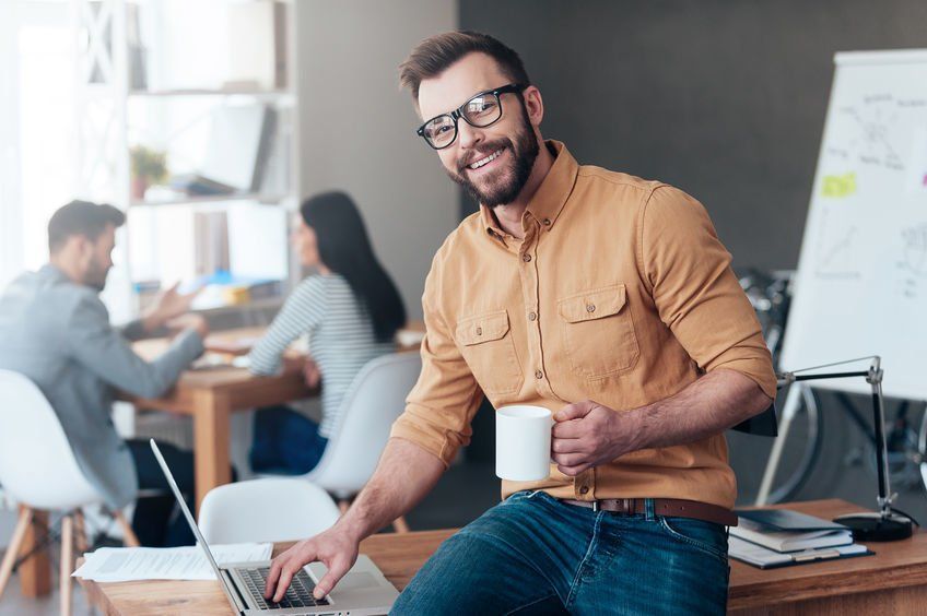 A smiling male IT professional working on an IT project.
