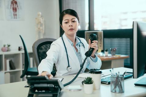 Female doctor making a phone call.