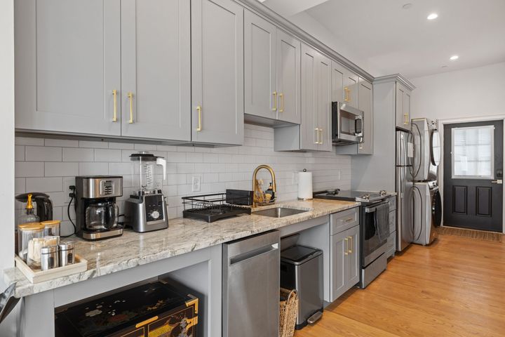 A kitchen with stainless steel appliances and granite counter tops.