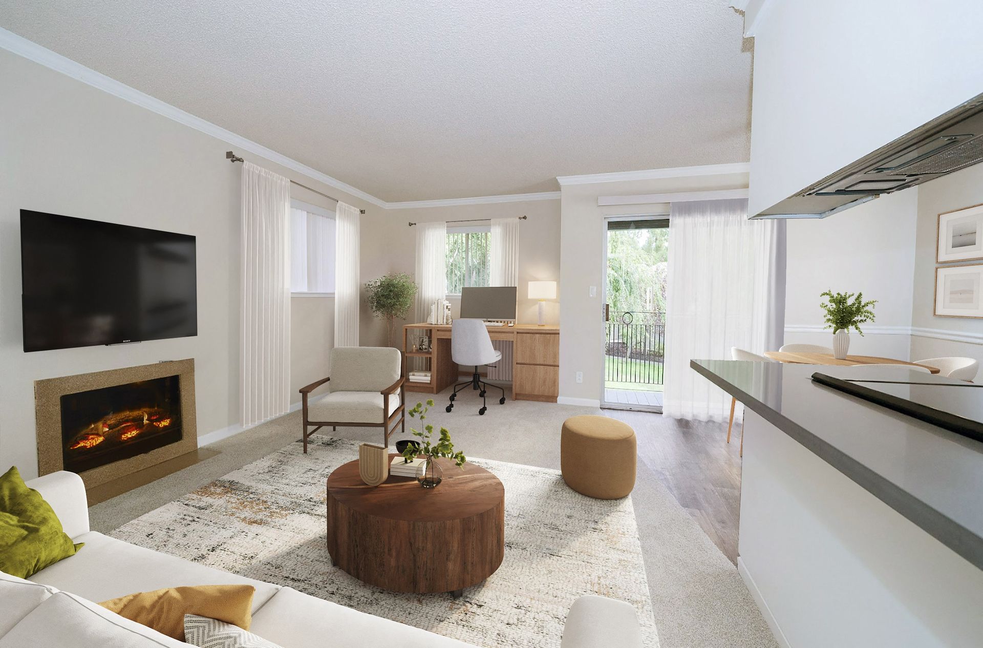 Bright apartment living room with fireplace, TV, desk, and sliding balcony doors.