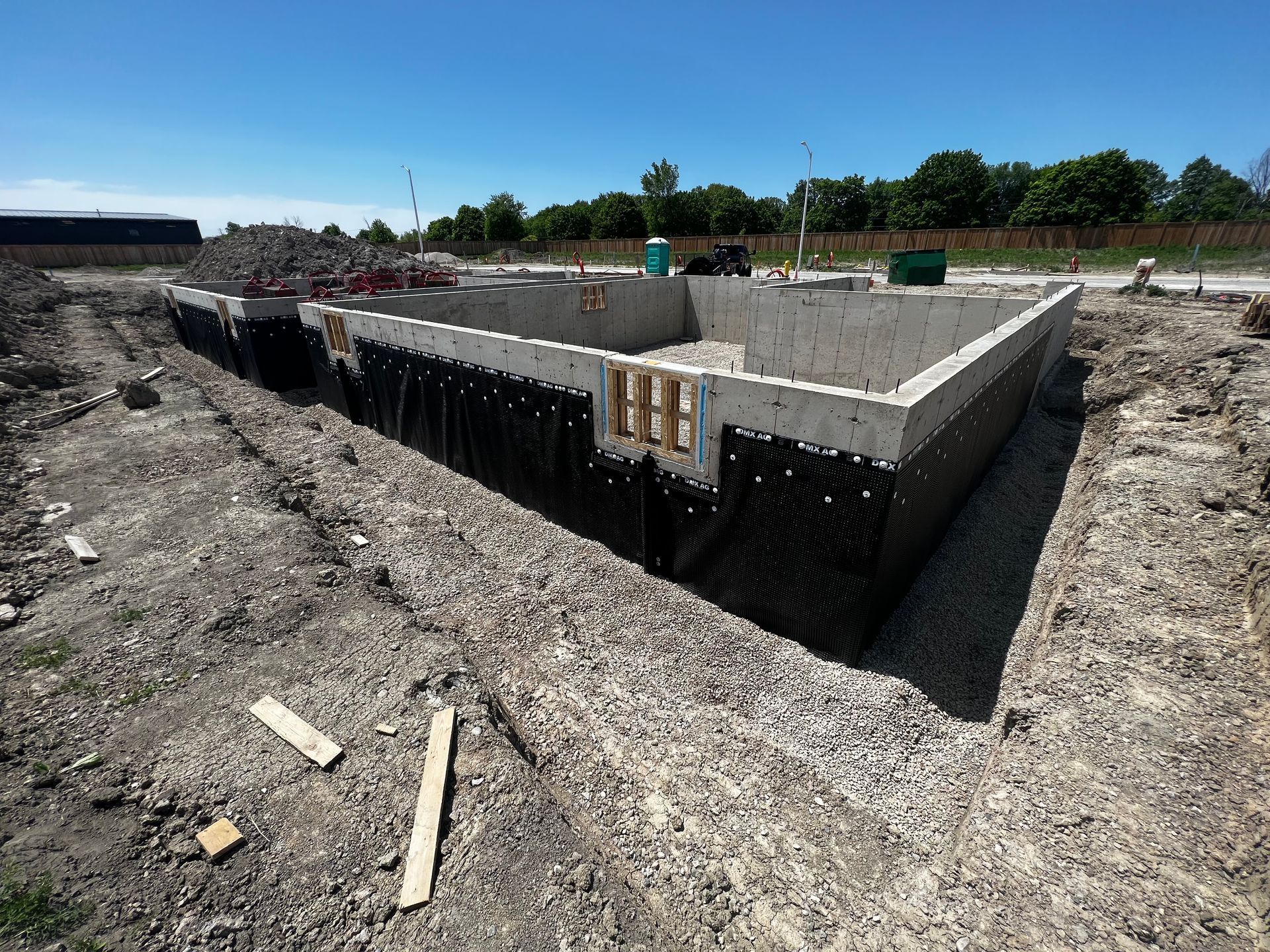 A large concrete foundation that has waterproof DMX membrane correctly installed, verifying the warranty.