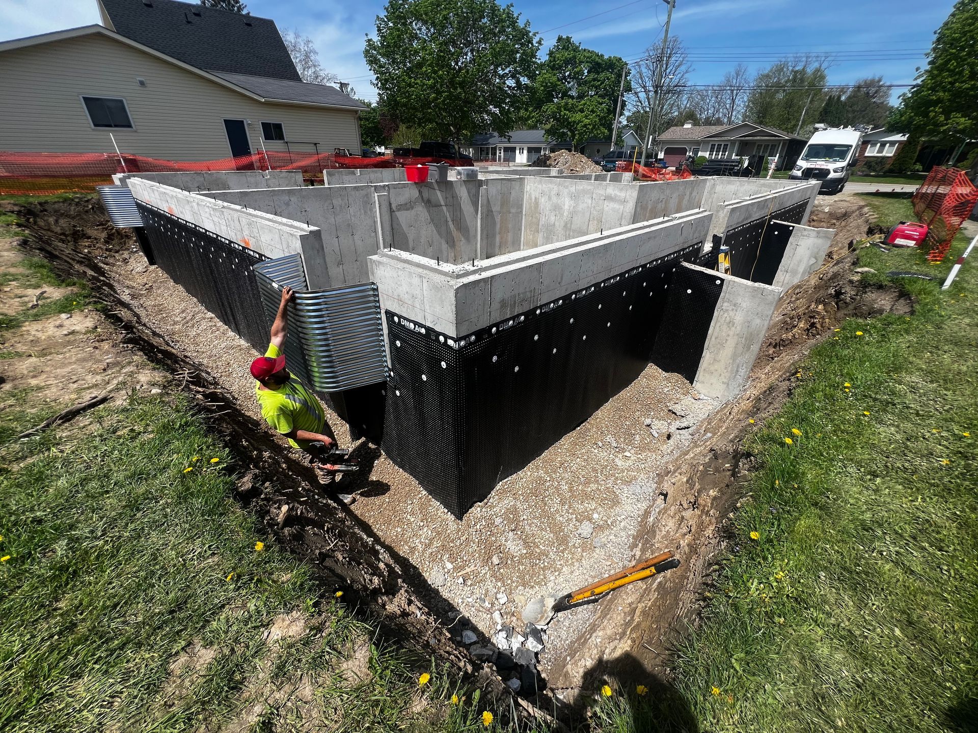 An employee of JD Waterproofing is installing a window well.