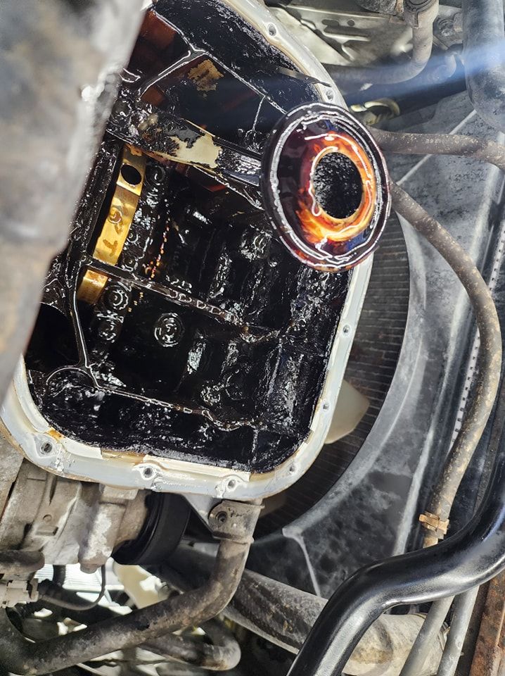 A Close Up Of A Car Engine With Oil Coming Out Of It — M8S Rates Mechanical In Gladstone Central, QLD