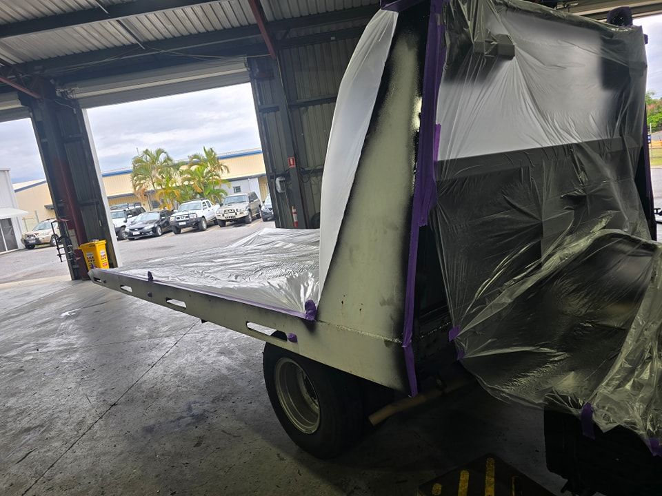 A Tow Truck Is Being Painted In A Garage — M8S Rates Mechanical In Gladstone Central, QLD