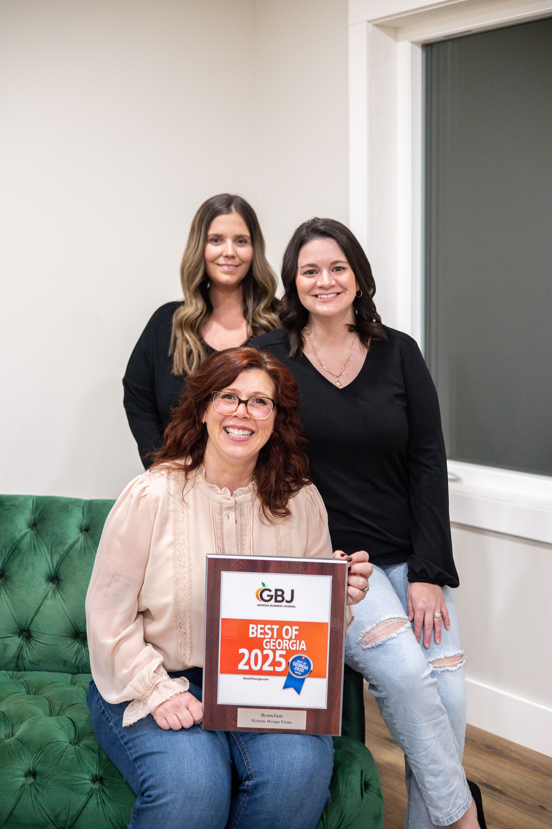 Three women pose with a