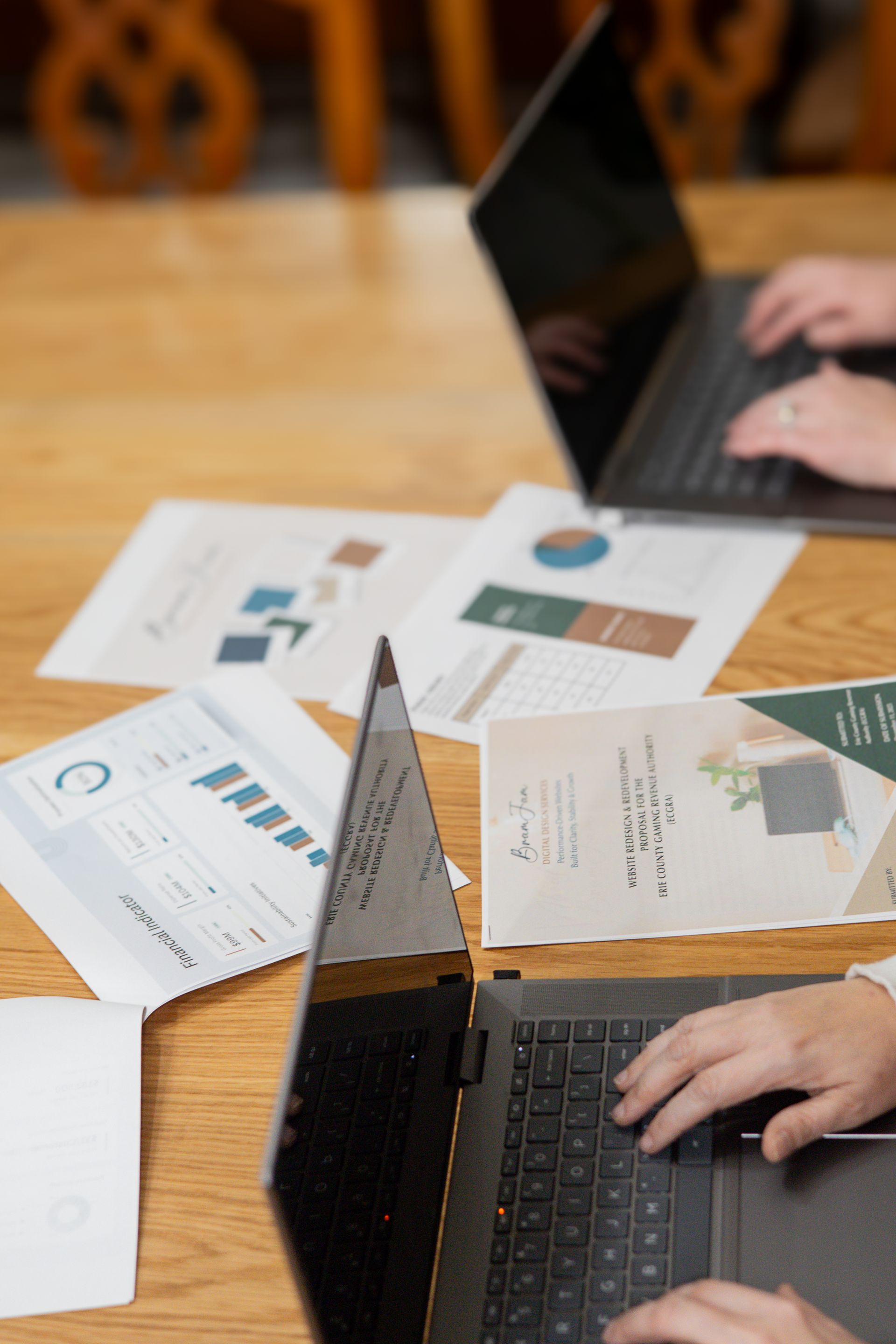 Person pointing at pie chart on a tablet displaying website analytics, holding a phone.