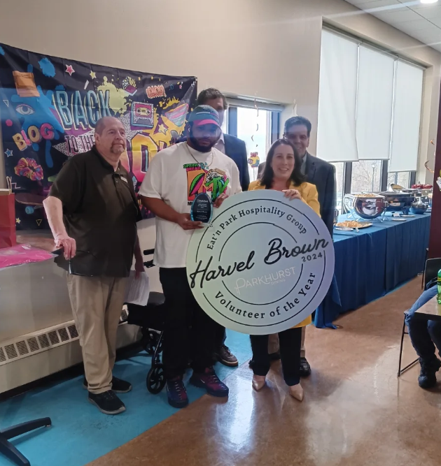 People holding an award that reads 