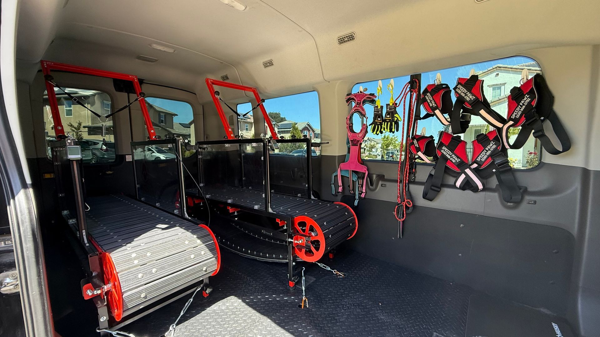 The inside of a van with a treadmill in the back.