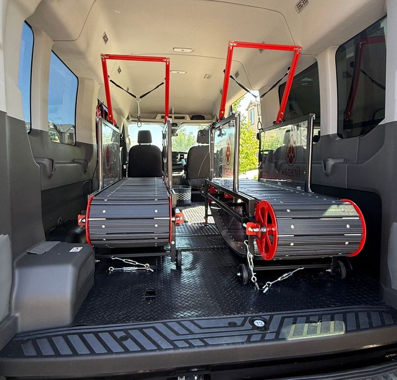 The back of a van with two stretchers in it