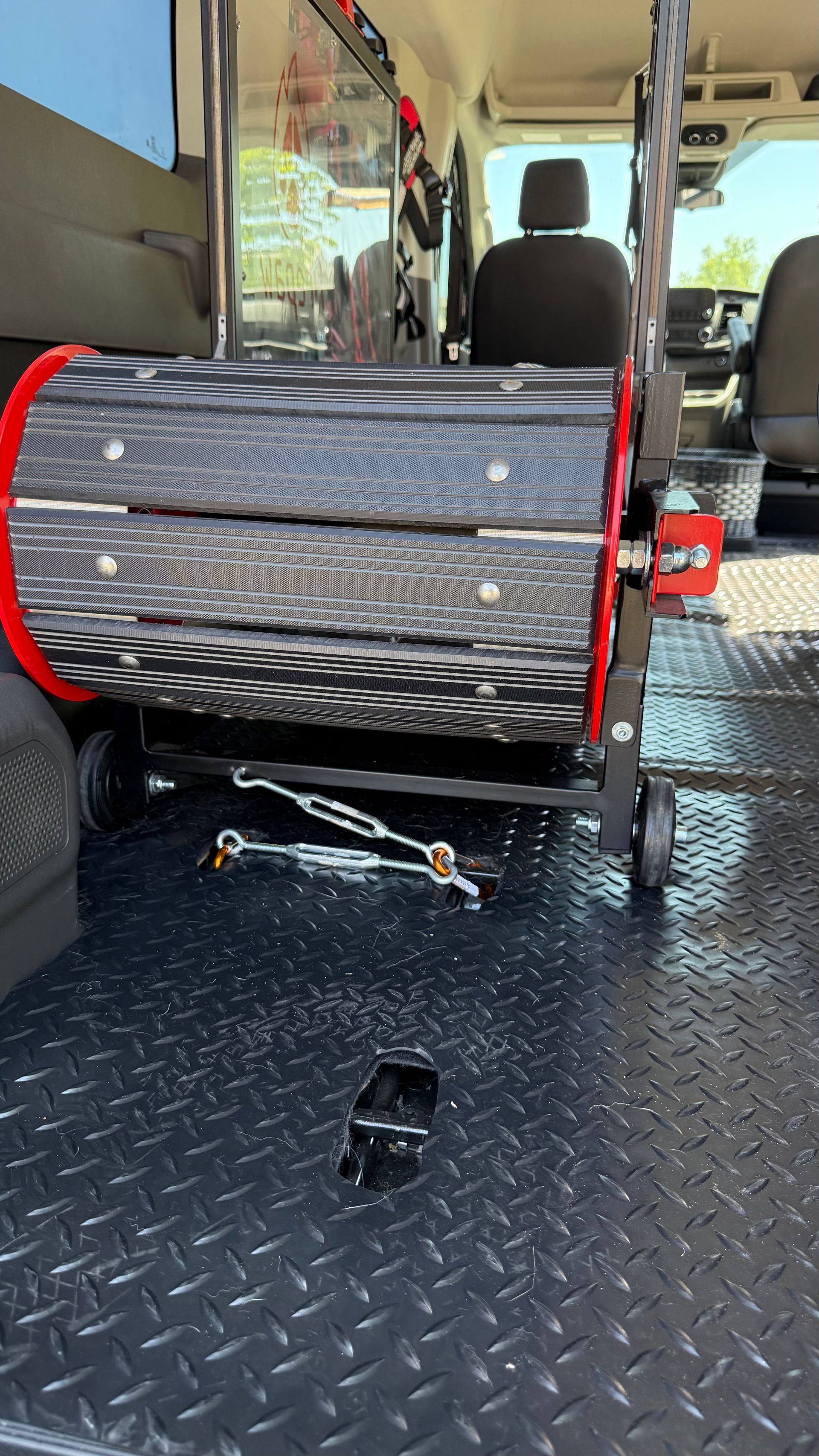 The back of a van with a wheelchair in the back.