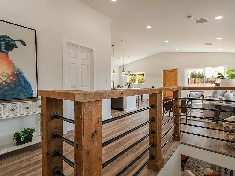 A man is installing an electrical outlet on a wall with a drill.