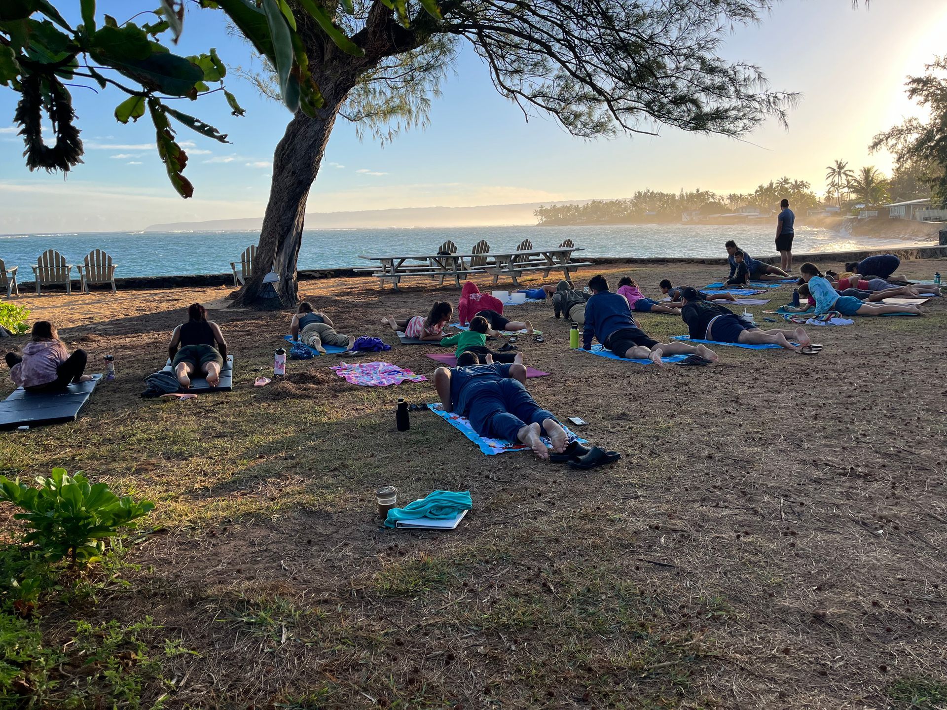 A group of people are doing yoga on the beach.