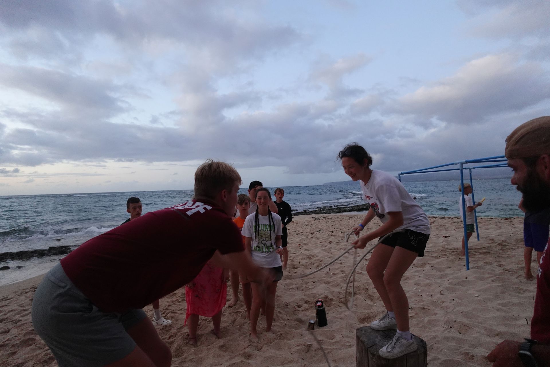 A group of children wearing helmets and harnesses are posing for a picture.