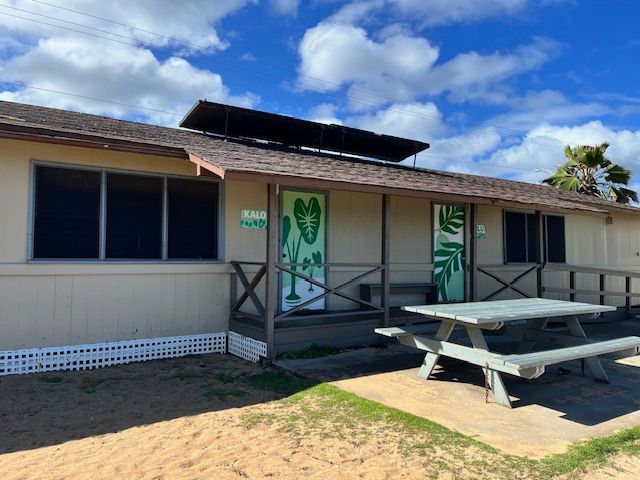 A house with a picnic table in front of it