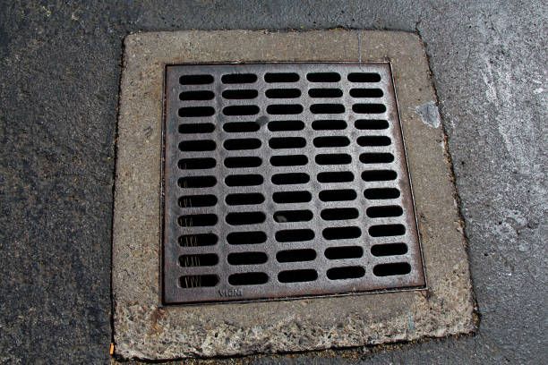 Drainer — Kalamazoo, MI — Modern Septic & Sewer A manhole cover on the side of a road.