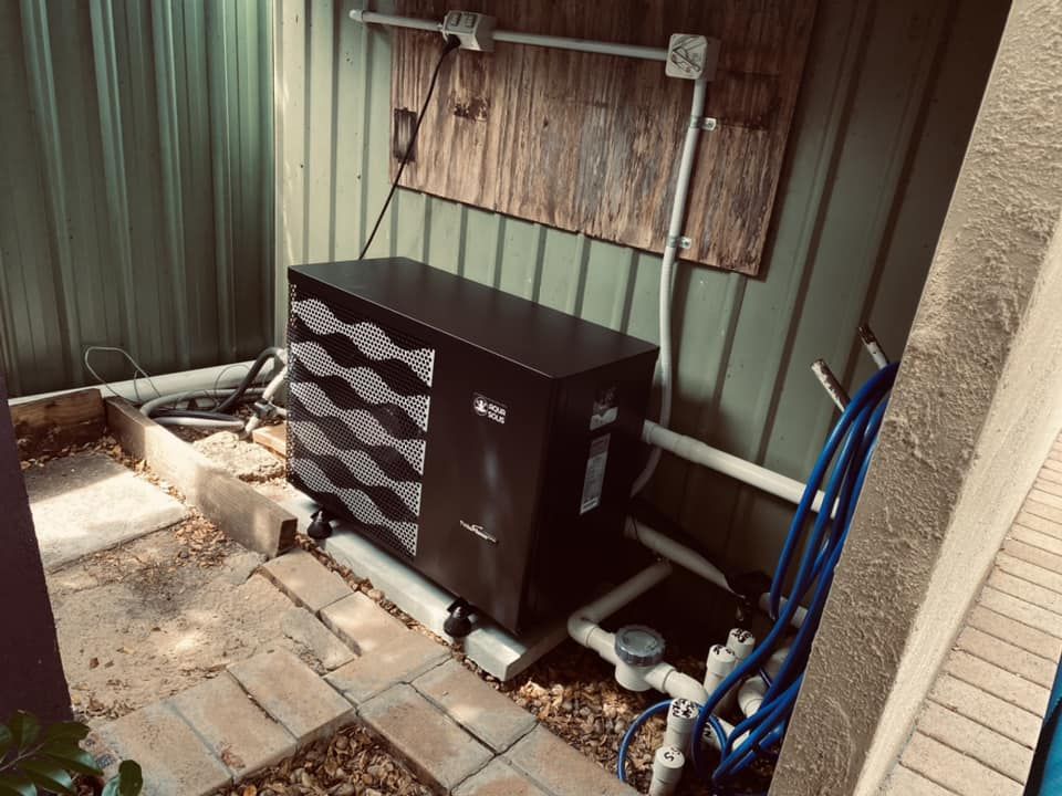 A Black Pool Heat Pump Outdoors — Tempshift Pool Heating in Central Coast, NSW