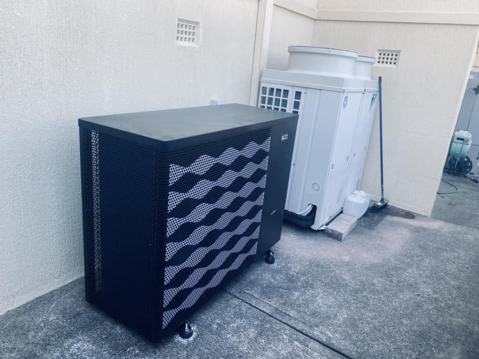 Black Pool Heater Against a White Wall — Tempshift Pool Heating in Wyong, NSW