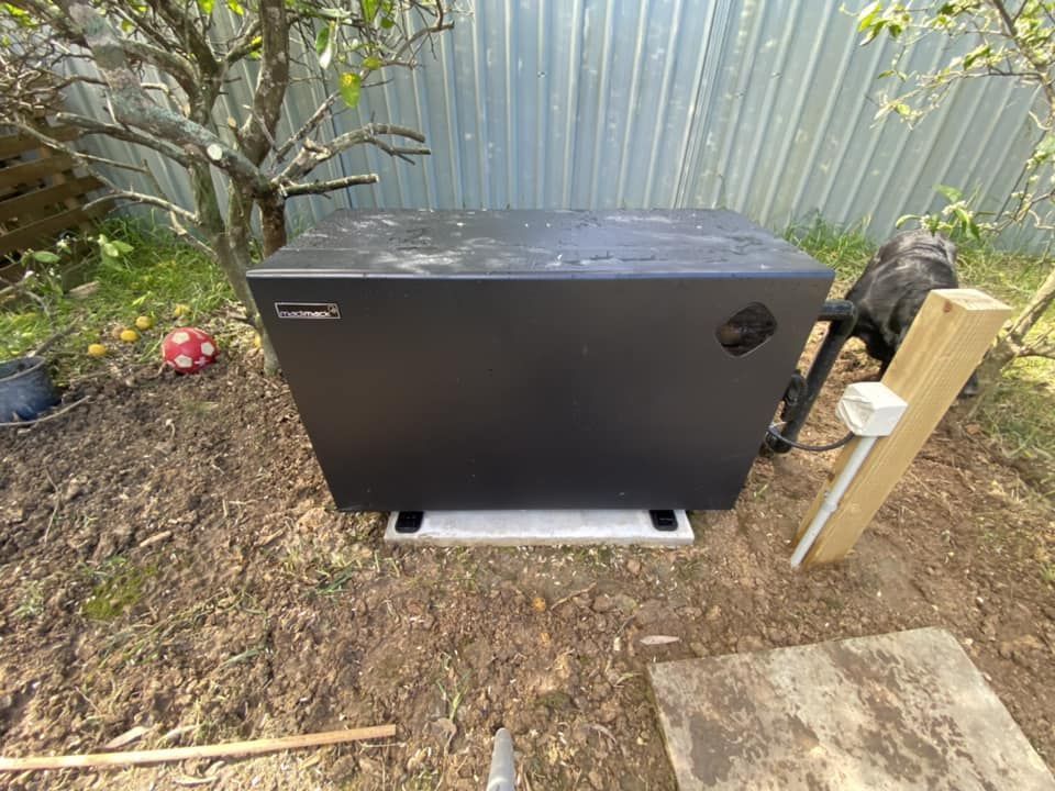 Black Pool Heater on Concrete Base in a Yard — Tempshift Pool Heating in Gosford, NSW