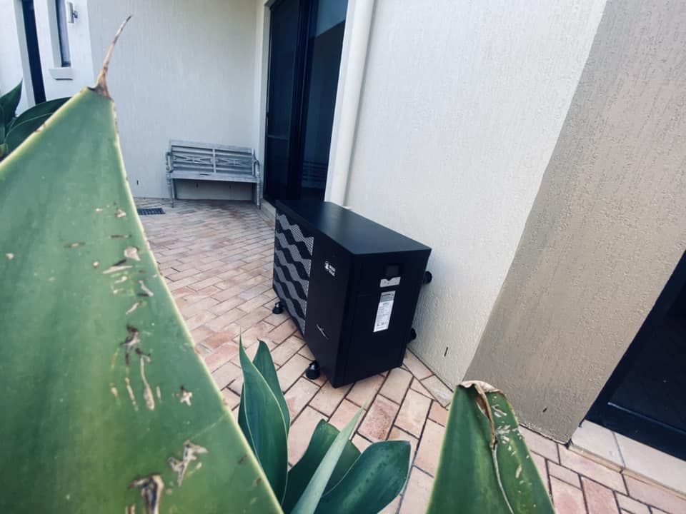 Black Pool Heater in an Outdoor Courtyard — Tempshift Pool Heating in Newcastle, NSW