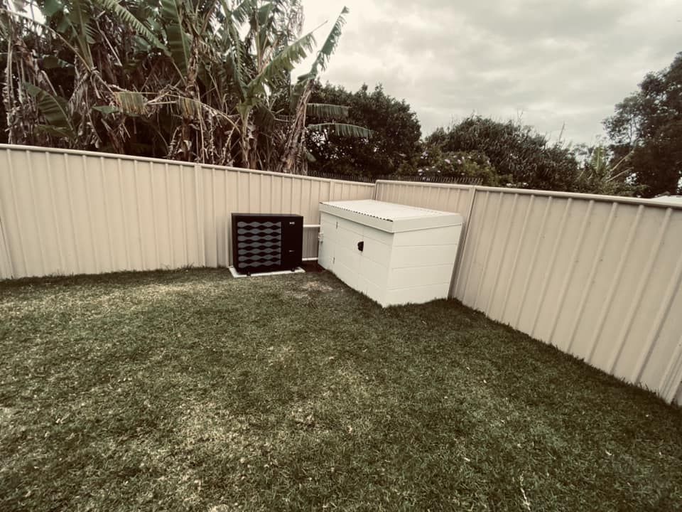 Lawn With a White Fence, and a Pool Heater in a Backyard — Tempshift Pool Heating in Hunter Valley, NSW