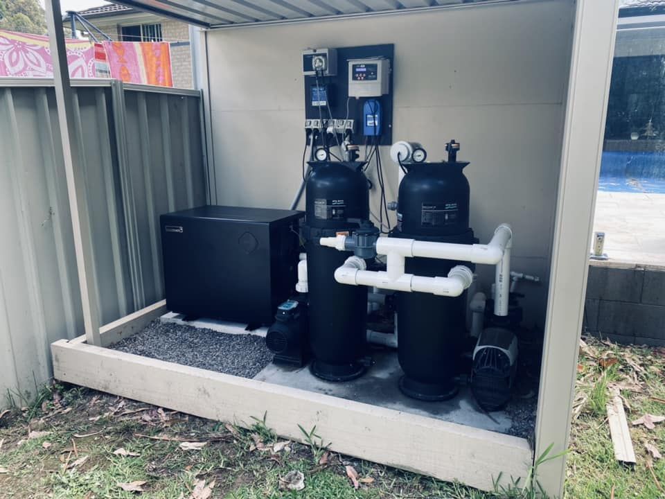 A Black Heater and Filtration System, Housed Under a Metal Shelter — Tempshift Pool Heating in Buff Point, NSW