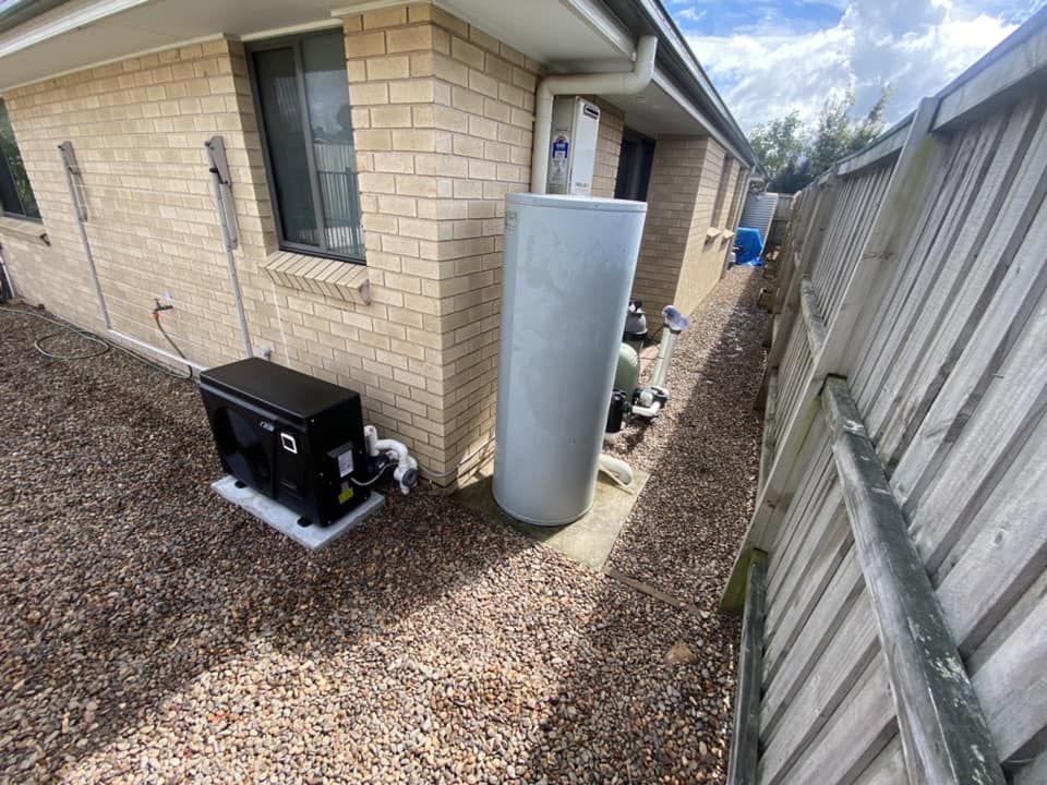 A Residential Backyard Featuring a Water Heater, Heat Pump, and Gravel Ground — Tempshift Pool Heating in Buff Point, NSW