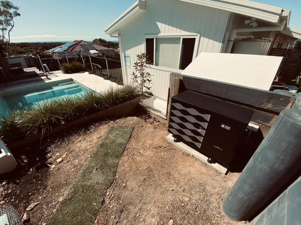 Poolside View of a Black Heat Pump Next to a House — Tempshift Pool Heating in Lake Macquarie, NSW