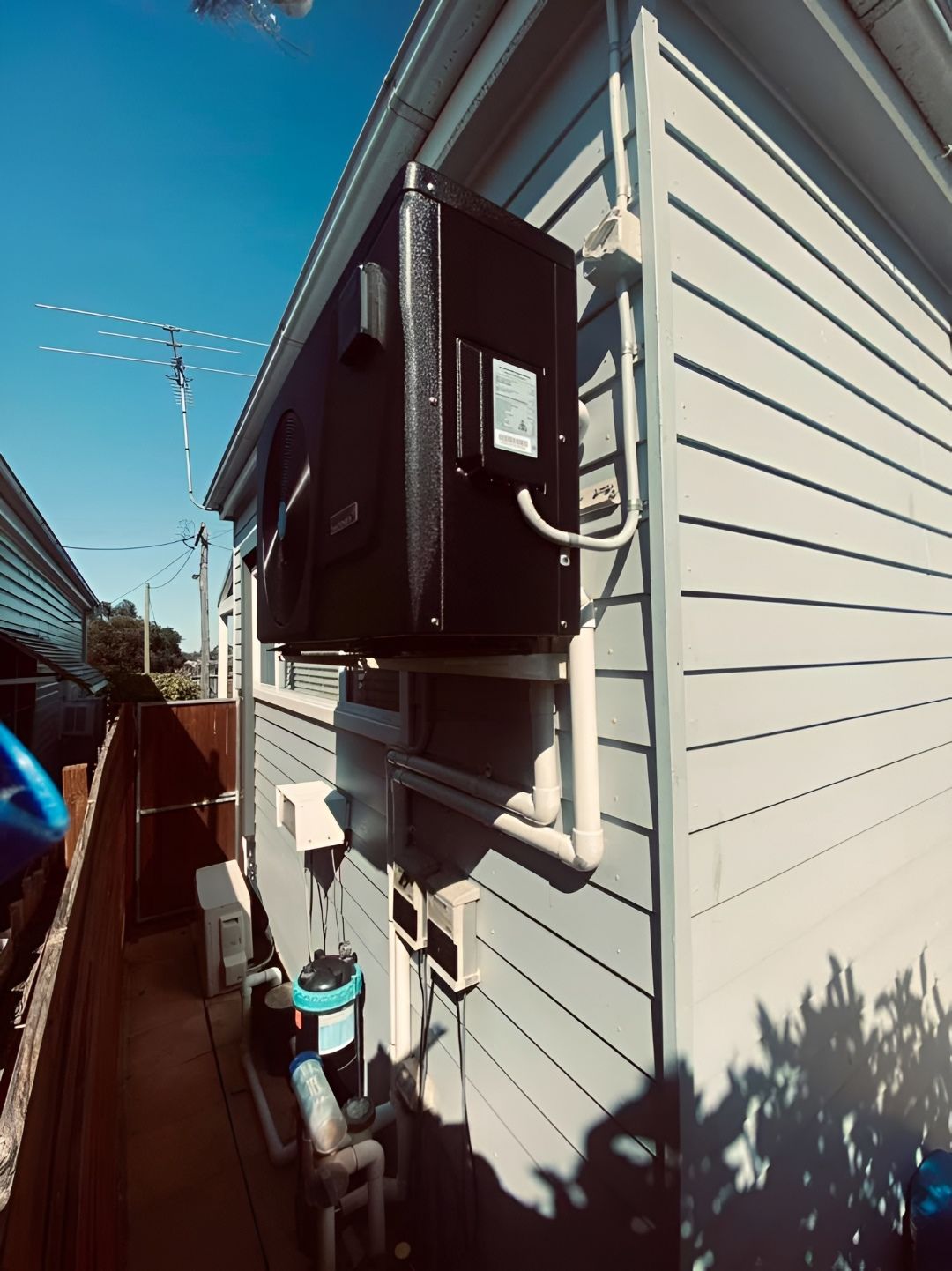 Black Pool Heater Mounted on the Side of a House — Tempshift Pool Heating in Buff Point, NSW
