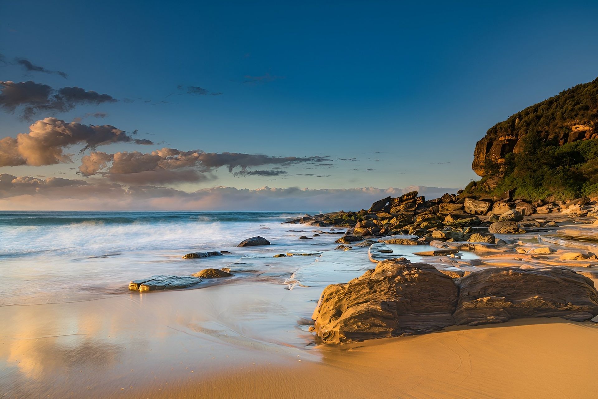 Beach at Sunset With Golden Sand, Blue Sky, and Rocks — Tempshift Pool Heating in Central Coast, NSW