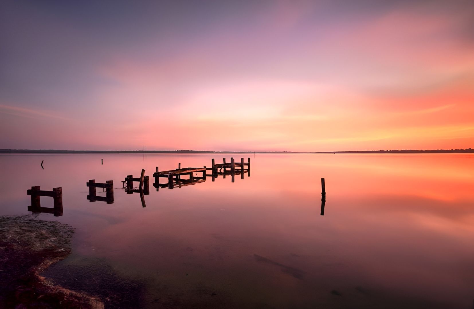 Sunset Over Calm Water, Reflecting Vibrant Pinks and Oranges — Tempshift Pool Heating in Wyong, NSW