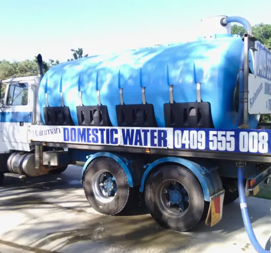 Worker Spraying Water on the Road — Rainman Domestic Water in Avoca, QLD