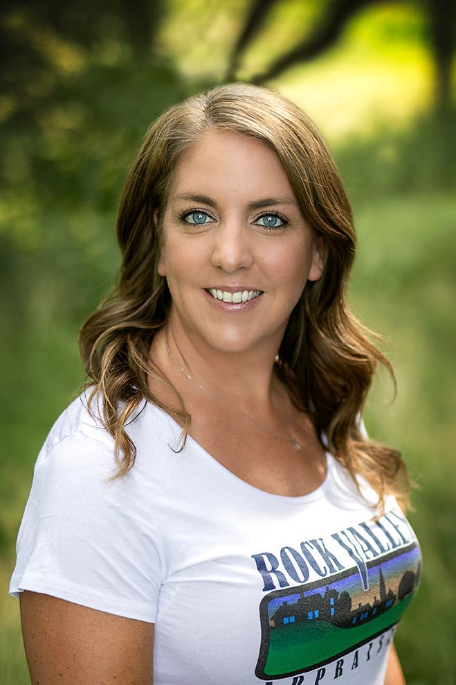 A man in a suit and white shirt is smiling for the camera.
