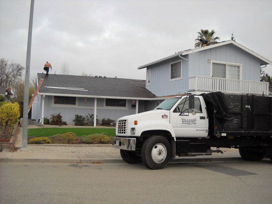 Roof — Blue House with a Man on top in Fremont, CA