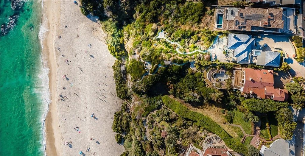 An aerial view of a beach with a lot of people on it.