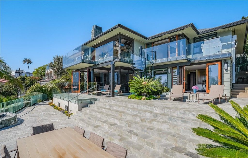 A large house with a lot of windows is for sale.