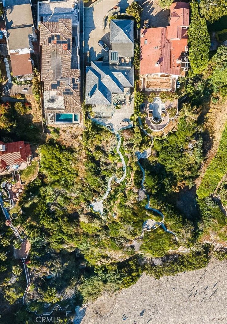 An aerial view of a residential area with lots of trees and houses.