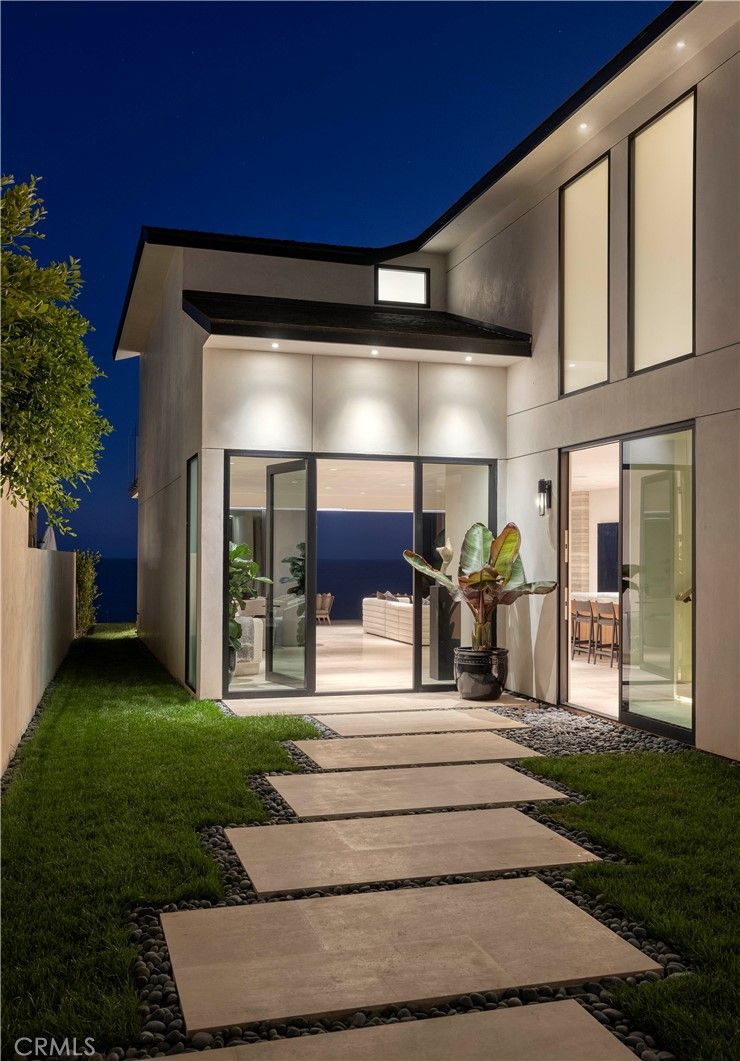 A white house with a walkway leading to it