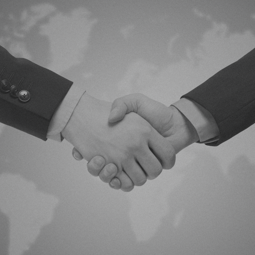 A black and white photo of two people shaking hands