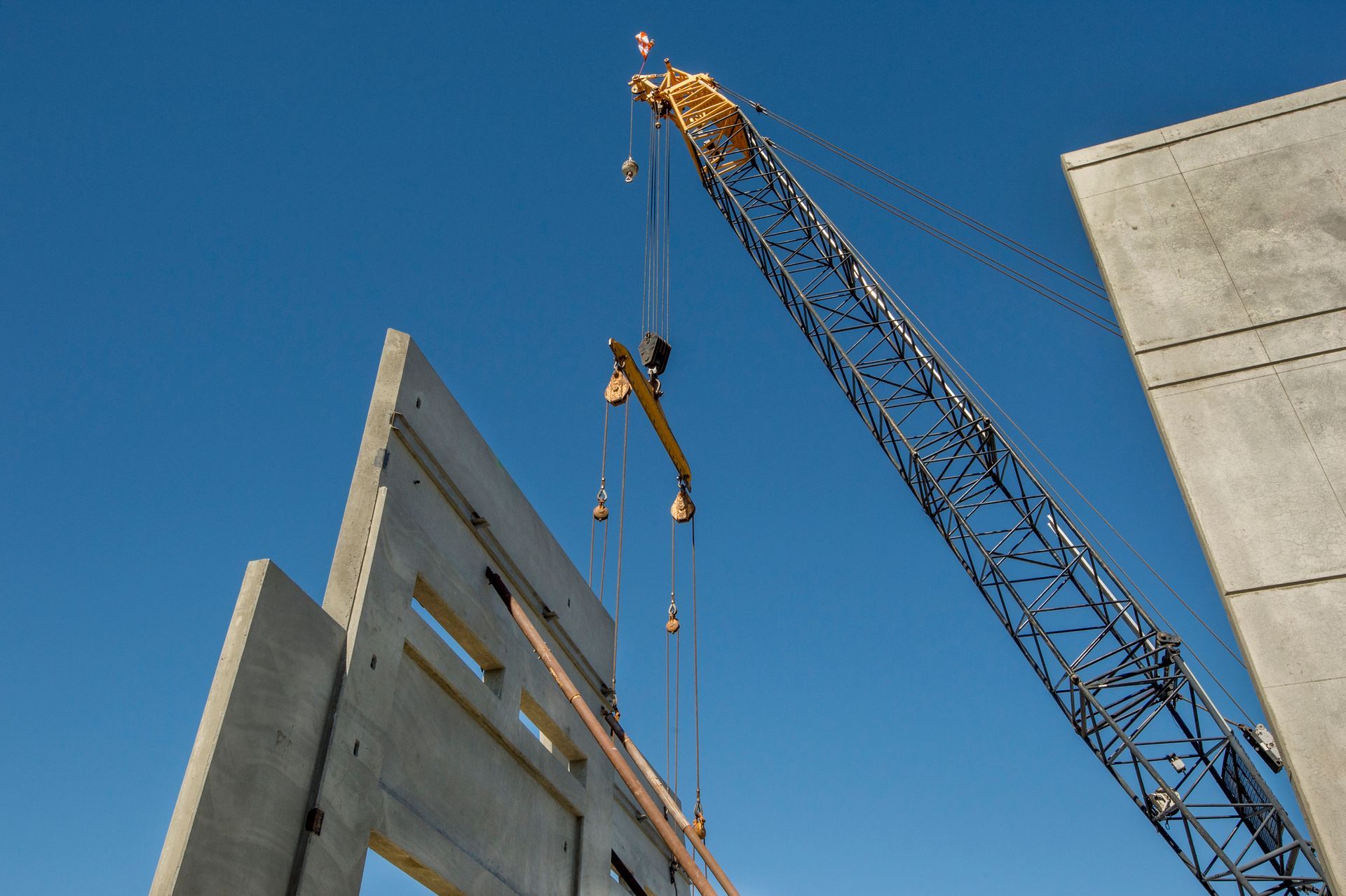 Construction Attorneys looking at a crane lifting a large crane