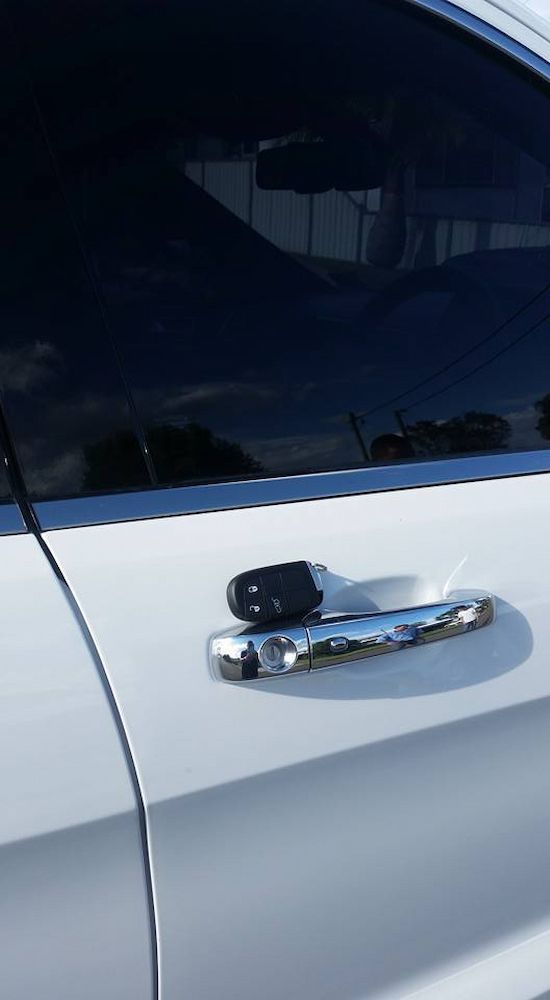 A Close Up of a Car Door With a Key in It — South Coast Locksmiths in Fairy Meadow, NSW