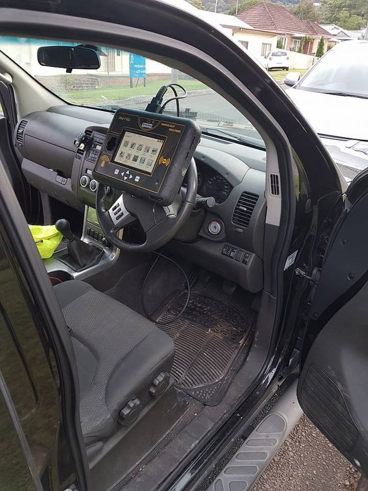 The Inside of a Car With the Door Open and a Tablet on the Dashboard — South Coast Locksmiths in Fairy Meadow, NSW